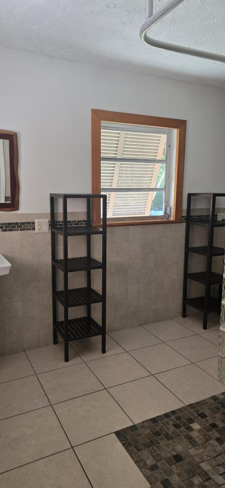 16 Pompano Avenue Key Largo, FL 33037 - Photo 10 of 23 a view of a room with rack on the wall and a window