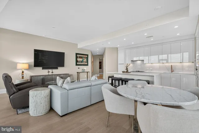 a dining room with furniture and a floor to ceiling window