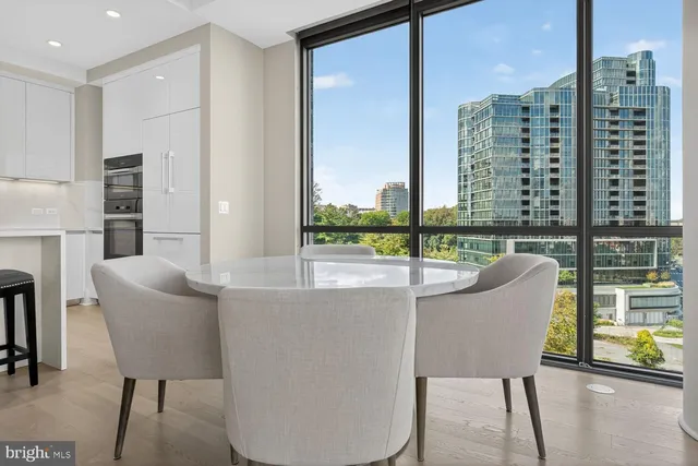 a living room with furniture and two window
