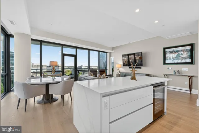 a large kitchen with stainless steel appliances granite countertop a lot of counter space a sink and dishwasher a stove top oven with wooden floor