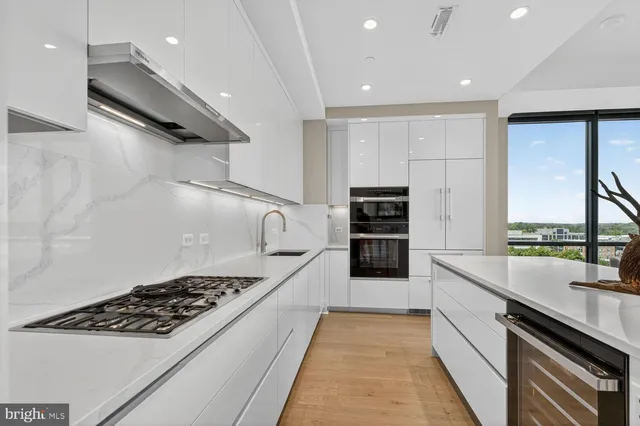 a bedroom with a bed and a lamp on dresser