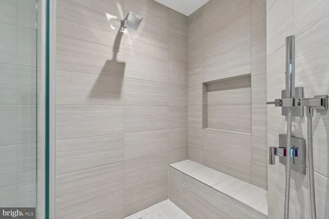 a bathroom with a glass shower door and mirror