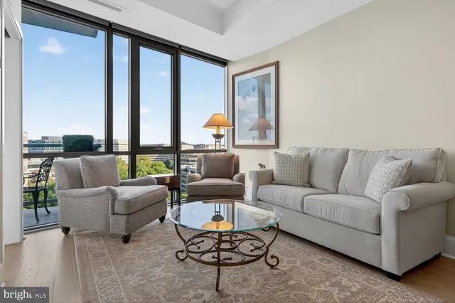 a view of a patio with table and chairs potted plants with large tree