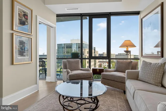 a patio with table and chairs and potted plants