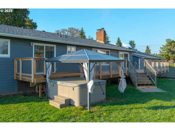 a backyard of a house with a garden and deck