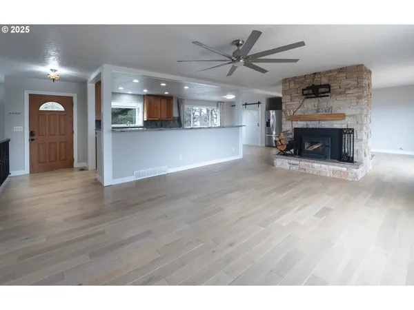 a view of a room window and wooden floor