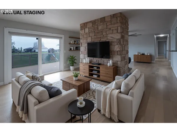a living room with furniture a flat screen tv and a floor to ceiling window