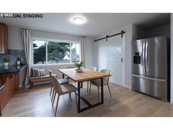 a dining room with furniture and a floor to ceiling window