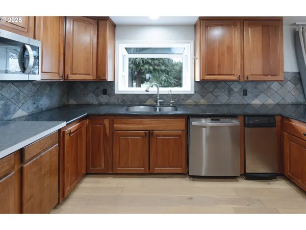 a kitchen with wooden cabinets