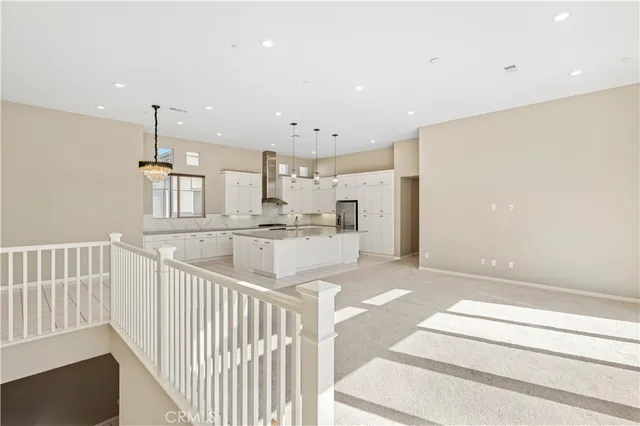 a large white kitchen with a large window