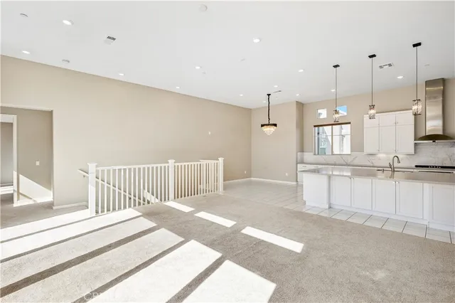 a kitchen with stainless steel appliances granite countertop a sink a stove and a refrigerator