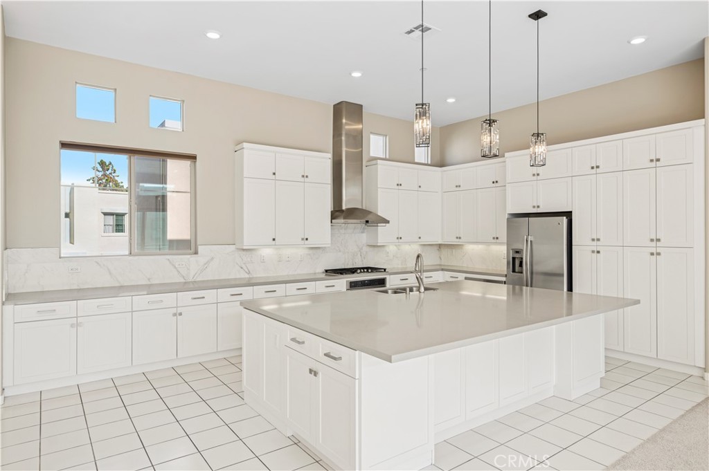 157 Terrapin Irvine, CA 92618 - Photo 7 of 19 a large kitchen with kitchen island a stove a sink a center island and windows