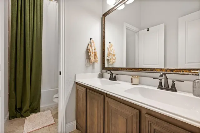 a bathroom with a double vanity sink and a mirror