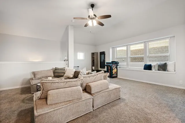 a living room with furniture and large windows