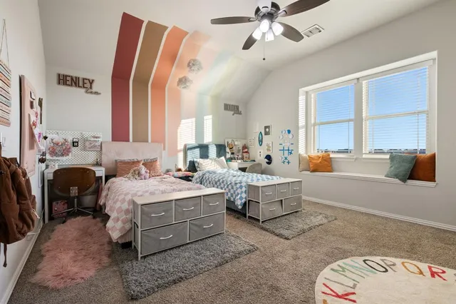 a spacious bedroom with a bed and a chandelier