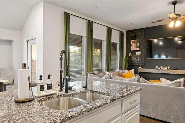 a kitchen with a sink and a large window