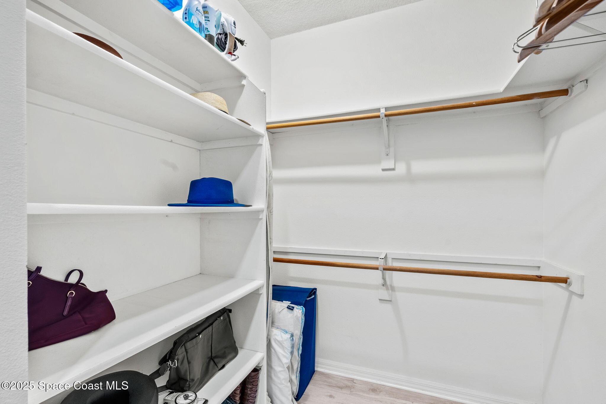 100 Riverside Drive, Unit 405 Cocoa, FL 32922 - Photo 23 of 90 a view of walk in closet with clothes and shoes