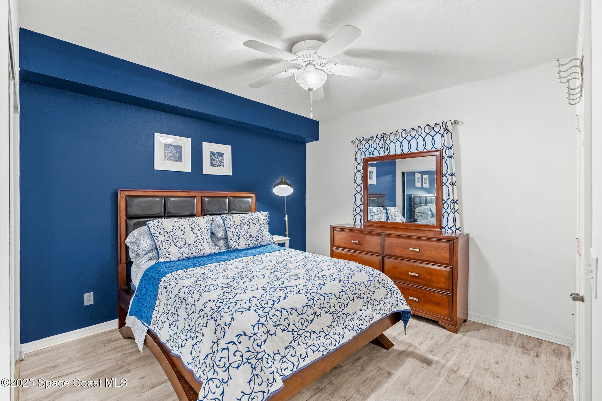 100 Riverside Drive, Unit 405 Cocoa, FL 32922 - Photo 27 of 90 a bedroom with a bed and a dresser in it