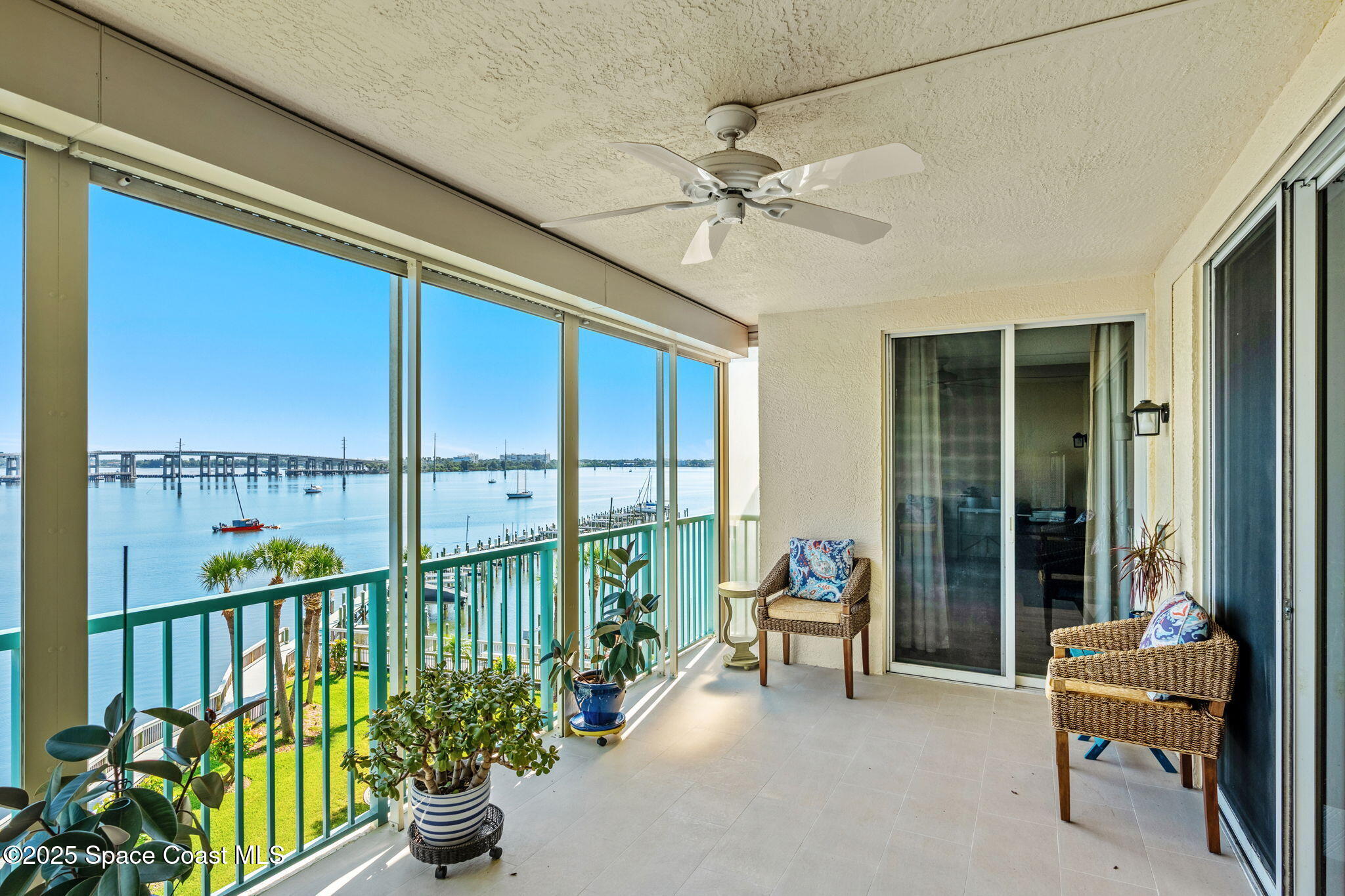 100 Riverside Drive, Unit 405 Cocoa, FL 32922 - Photo 34 of 90 a view of a chairs and table in patio with potted plants