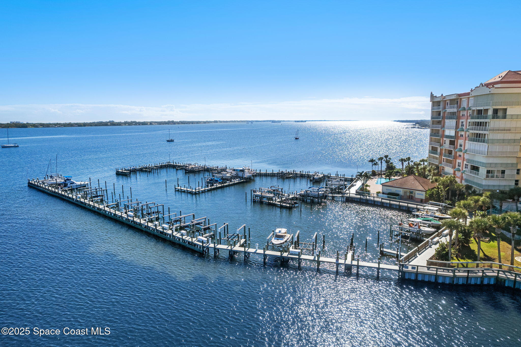 100 Riverside Drive, Unit 405 Cocoa, FL 32922 - Photo 65 of 90 a view of a ocean with boats and trees in the background