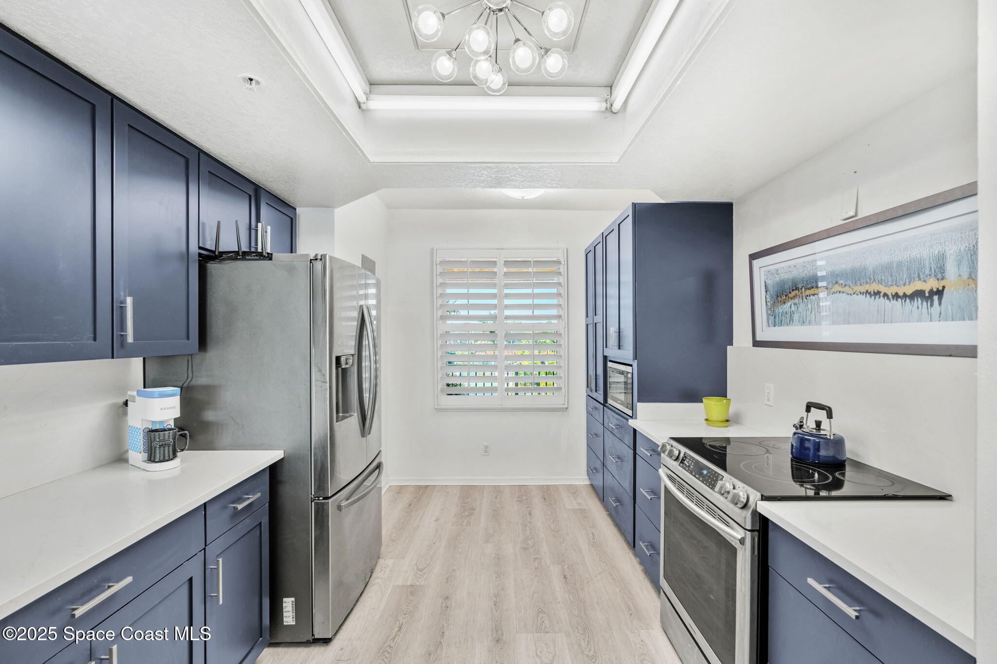 100 Riverside Drive, Unit 405 Cocoa, FL 32922 - Photo 7 of 90 a kitchen with stainless steel appliances a refrigerator a sink a stove and cabinets
