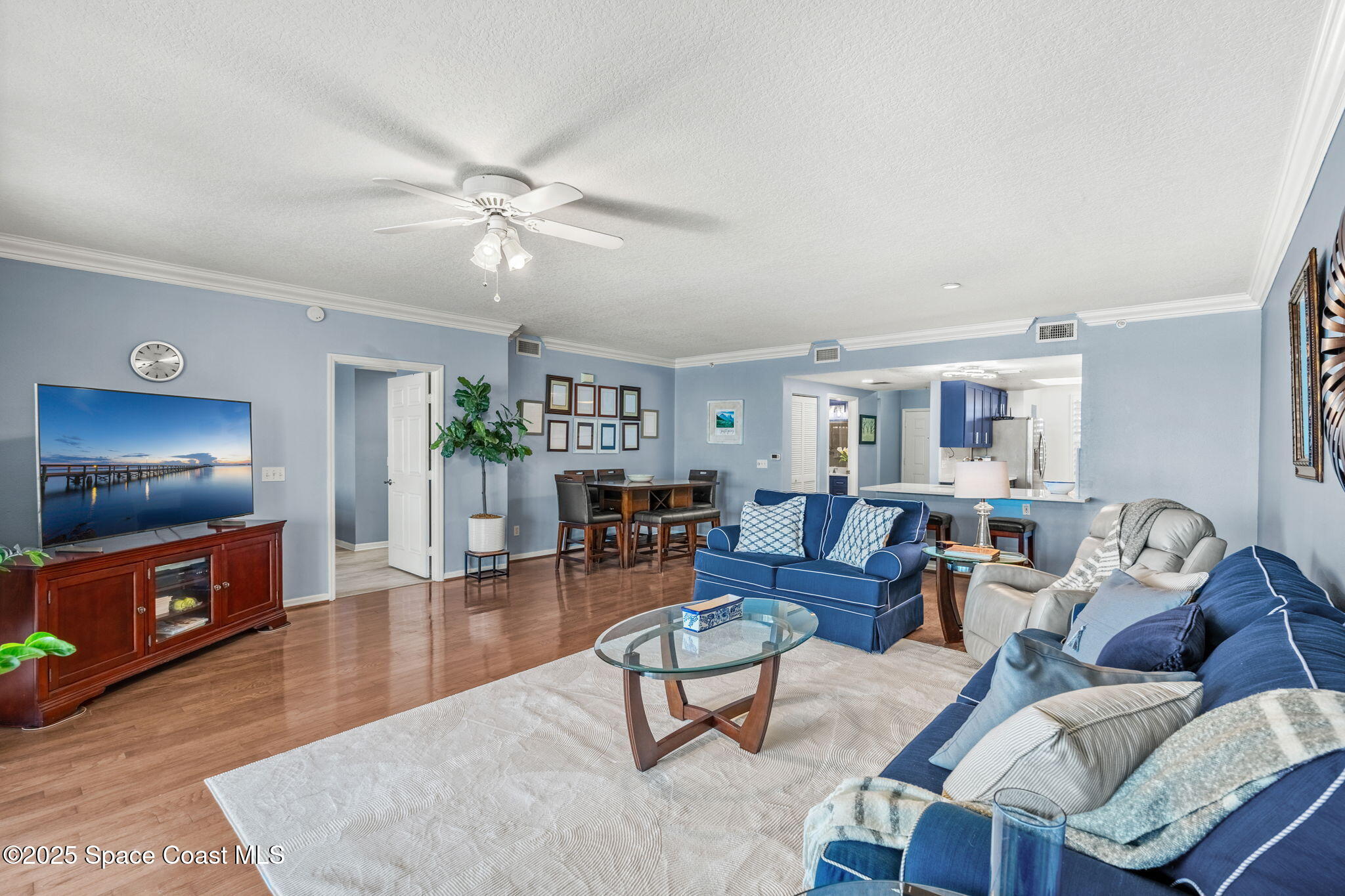 100 Riverside Drive, Unit 405 Cocoa, FL 32922 - Photo 88 of 90 a living room with furniture and a flat screen tv