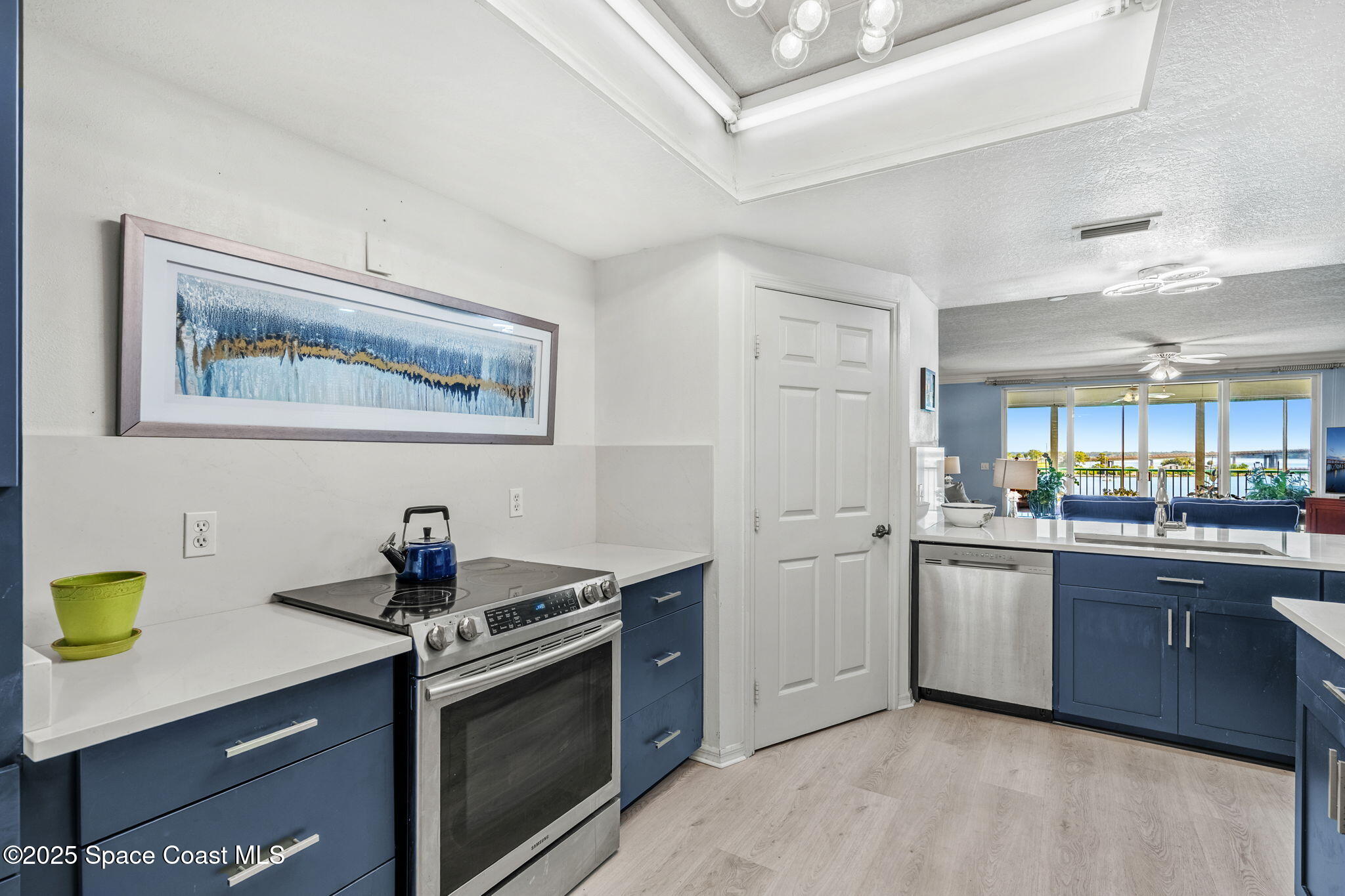 100 Riverside Drive, Unit 405 Cocoa, FL 32922 - Photo 9 of 90 a kitchen with stainless steel appliances a stove a sink and a refrigerator