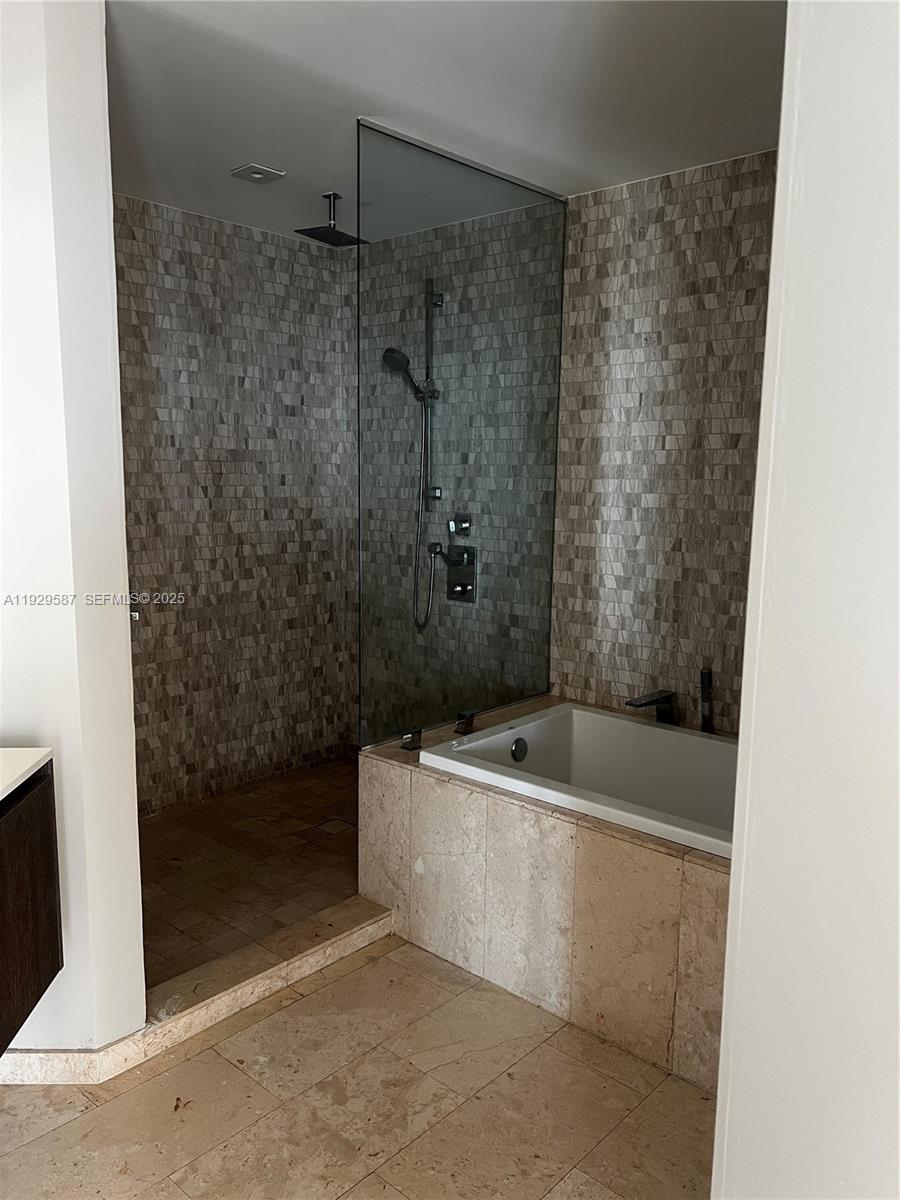 68 Southeast 6th Street, Unit 3401 Miami, FL 33131 - Photo 14 of 23 a bathroom with a bathtub and shower