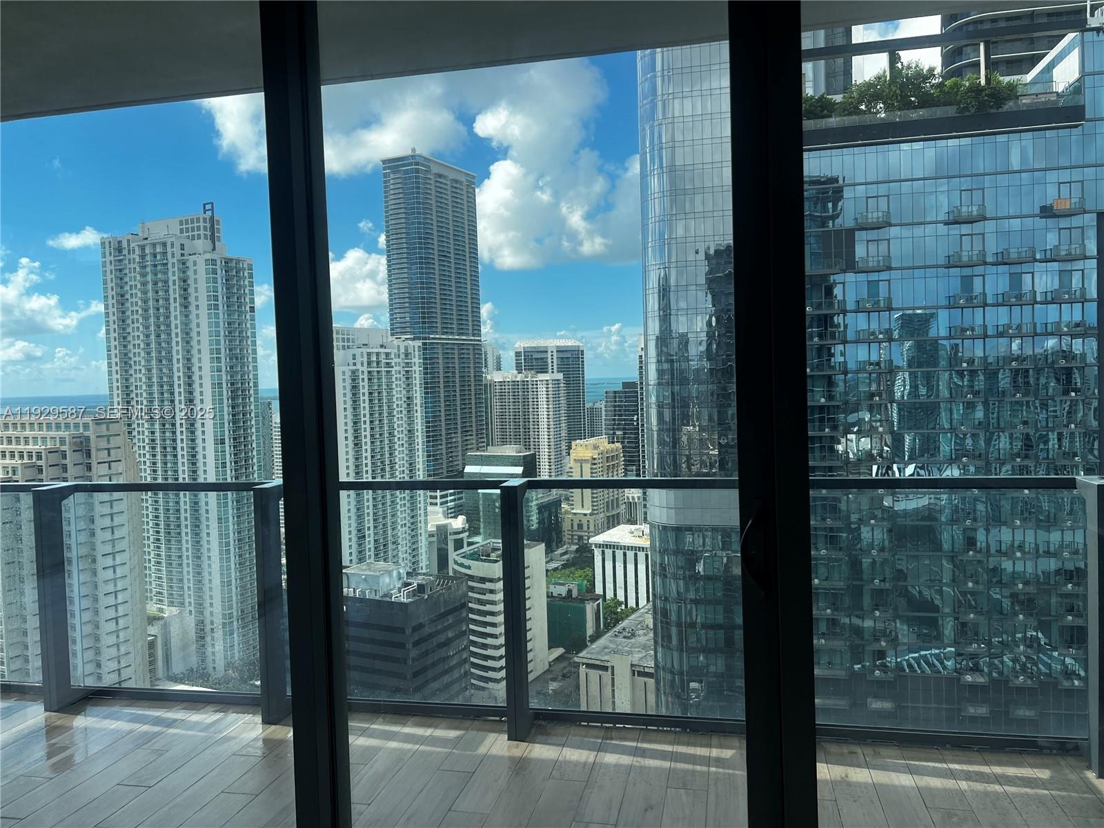 68 Southeast 6th Street, Unit 3401 Miami, FL 33131 - Photo 21 of 23 a view of a balcony with a floor to ceiling window