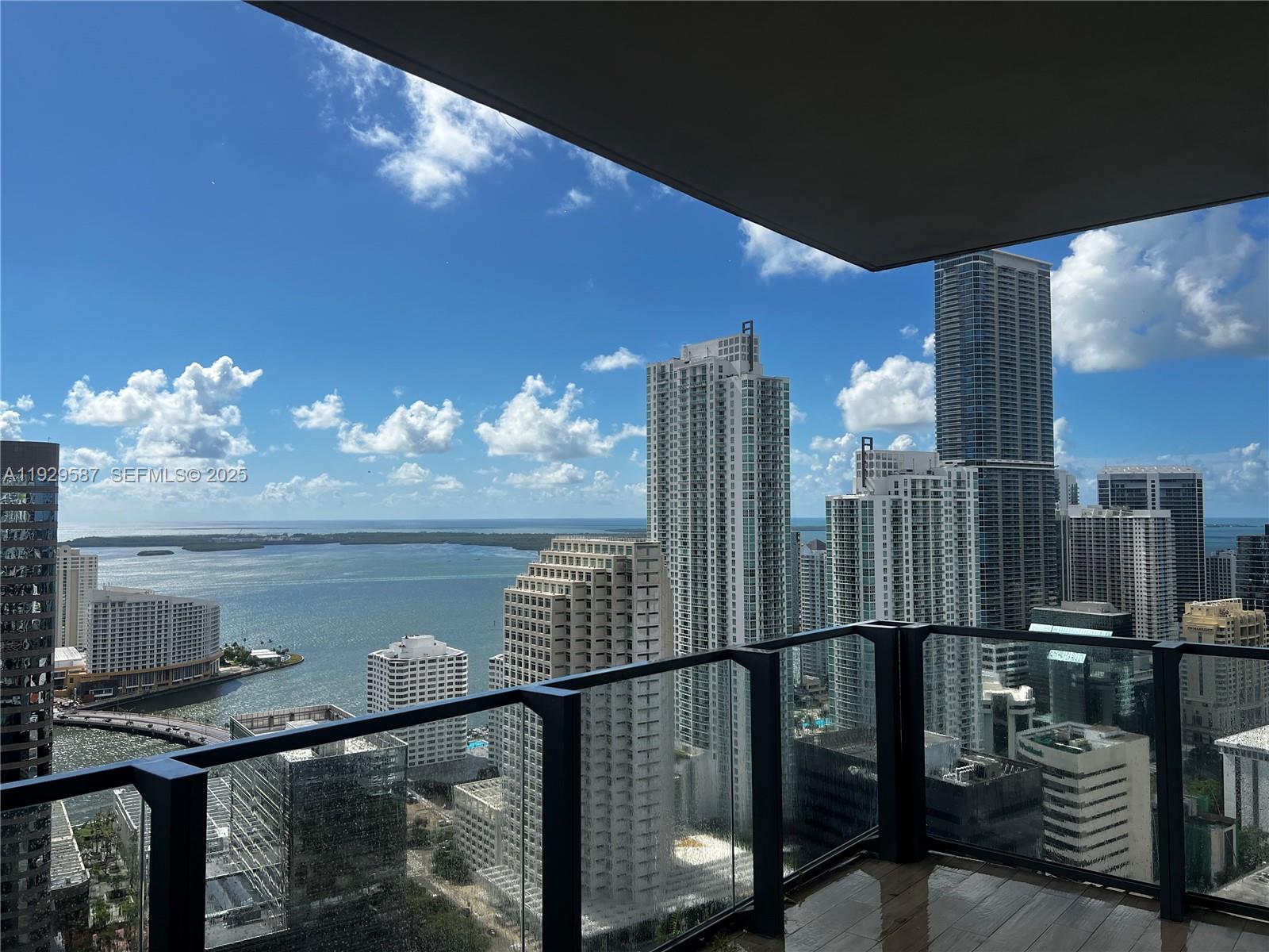 68 Southeast 6th Street, Unit 3401 Miami, FL 33131 - Photo 22 of 23 a view of a balcony with two chairs and a table
