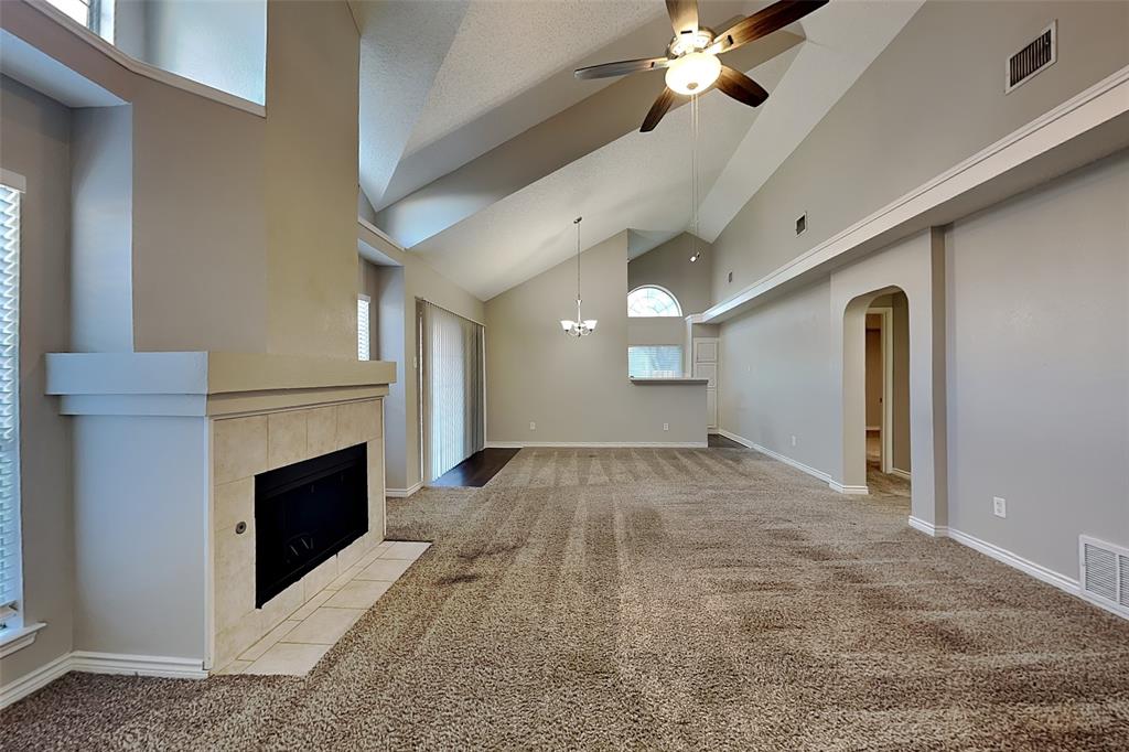 1213 Broken Arrow Trail Carrollton, TX 75007 - Photo 2 of 19 a view of empty room with fireplace and fan