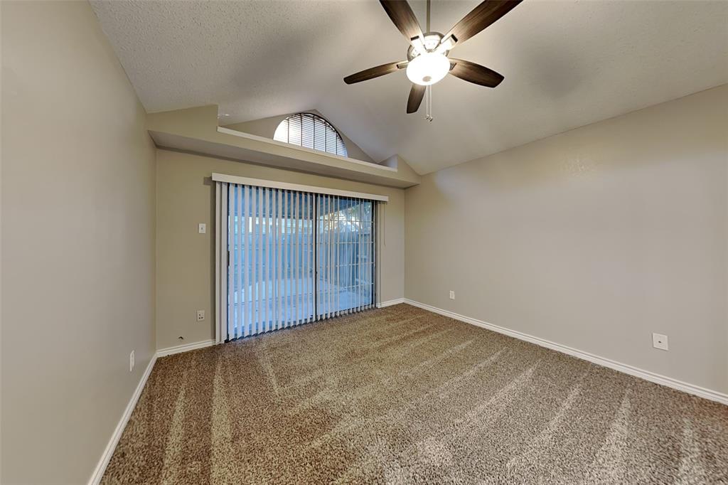 1213 Broken Arrow Trail Carrollton, TX 75007 - Photo 6 of 19 an empty room with chandelier fan and windows