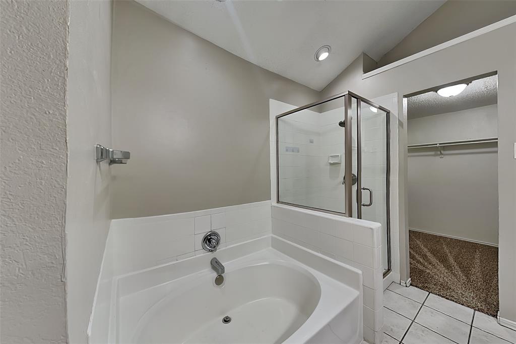 1213 Broken Arrow Trail Carrollton, TX 75007 - Photo 8 of 19 a bathroom with a bathtub and a shower