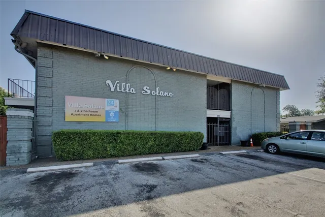 a front view of a building with parking area