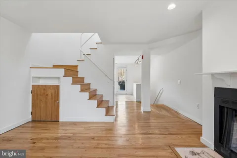 a view of entryway and hall with wooden floor