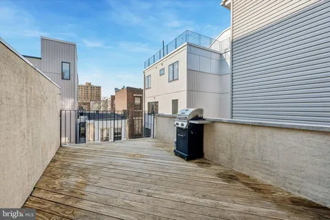 a view of a terrace with wooden floor and fence