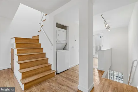 a view of entryway and hall with wooden floor