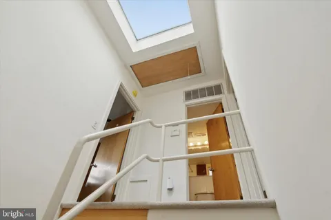 a view of staircase with white walls and a window
