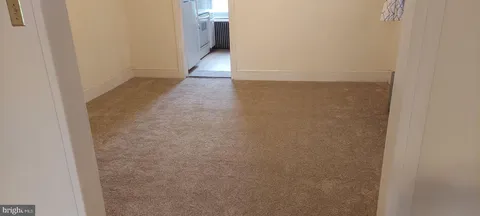 a view of a kitchen with stove and refrigerator