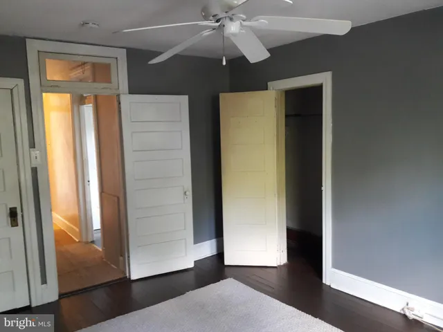 a view of a livingroom with a ceiling fan and window