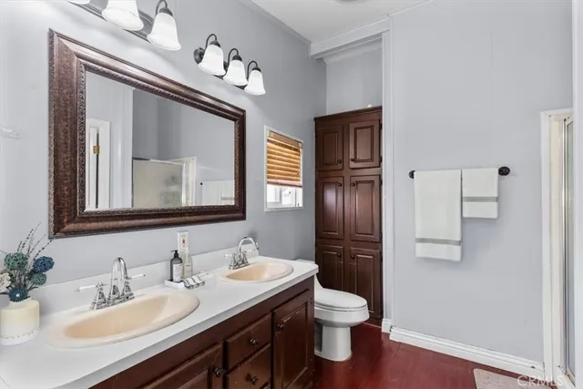 a bathroom with a toilet sink and mirror