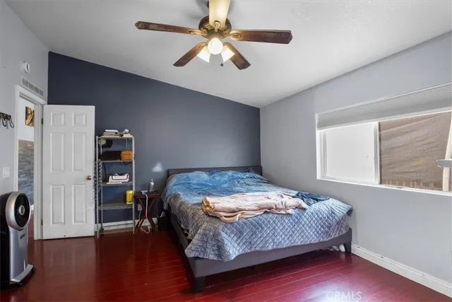 a bedroom with a bed and a book shelf