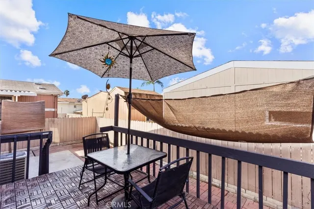 a view of a balcony with a table and chairs