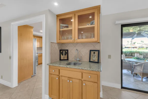a kitchen with granite countertop a sink and cabinets
