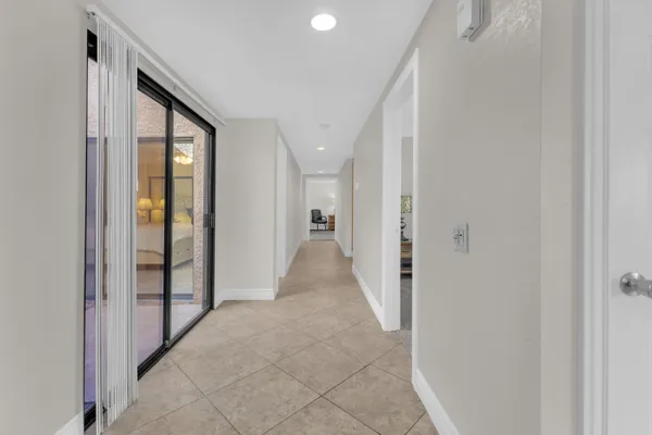 a view of a hallway with wooden shelves