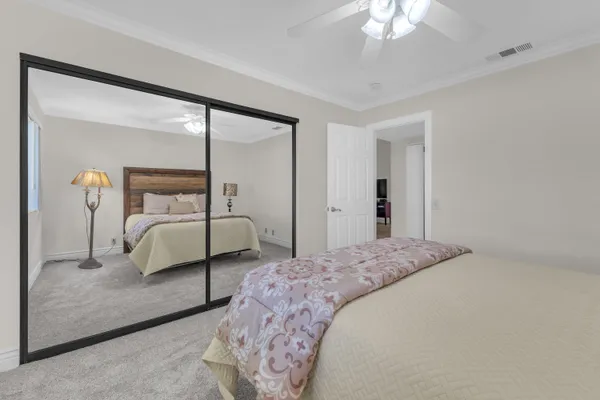 a bedroom with a bed and a mirror