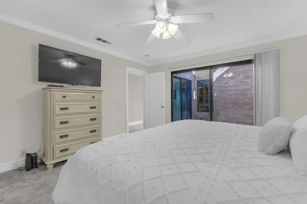 a bedroom with a large bed and flat tv screen