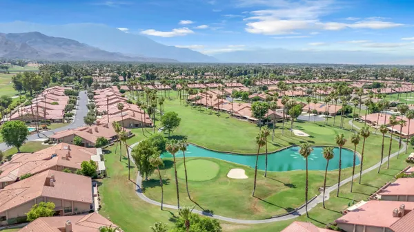 an aerial view of residential houses with outdoor space and swimming pool