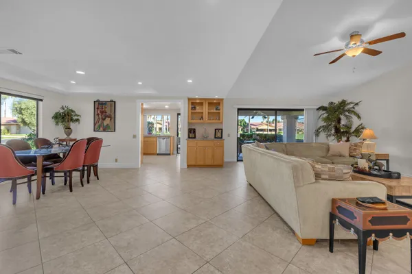a living room with furniture and a dining table with kitchen view