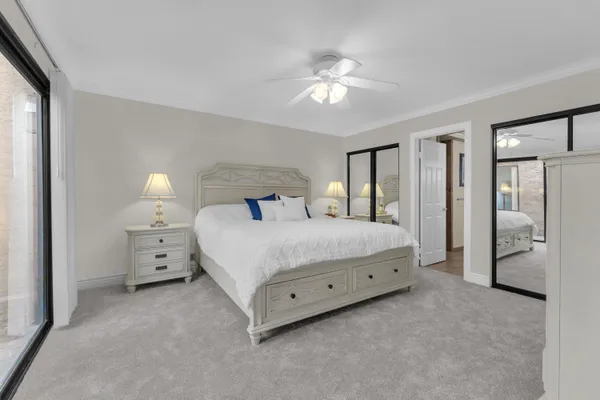 a bedroom with a large bed and a chandelier